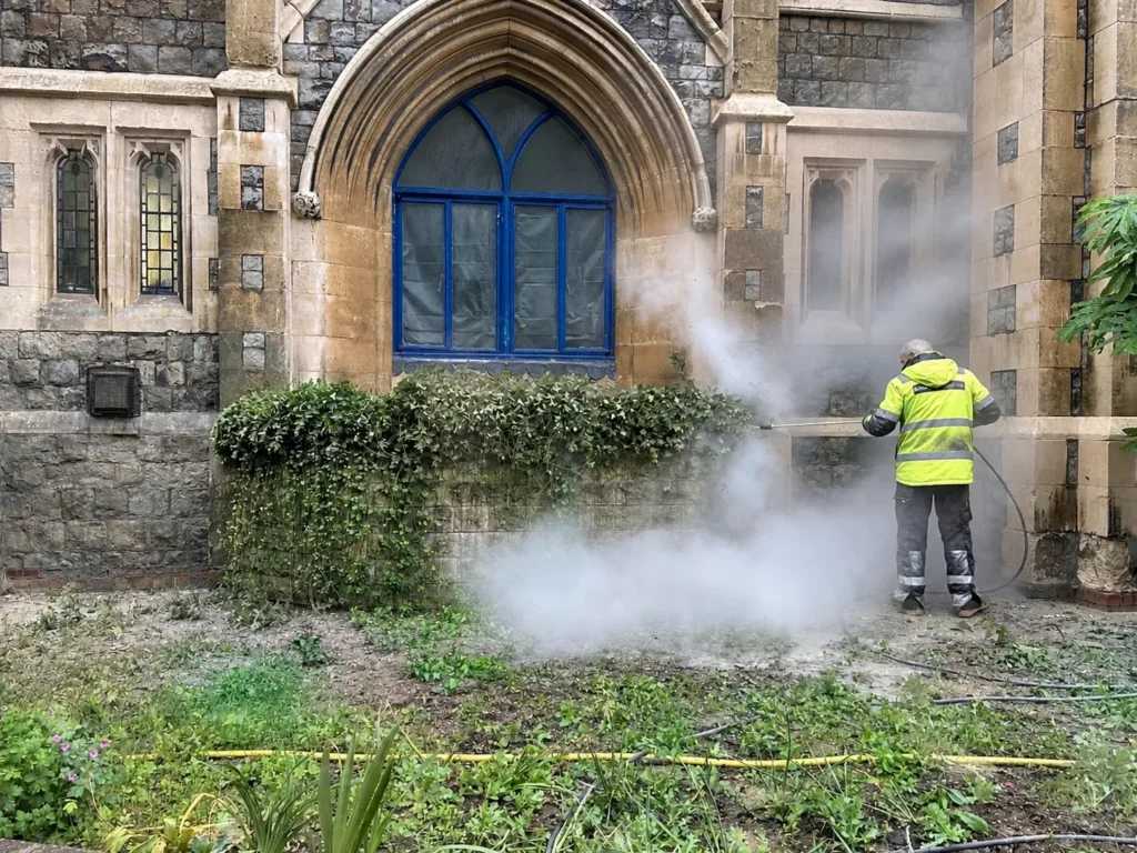 professional pressure washing service cleaning a building exterior
