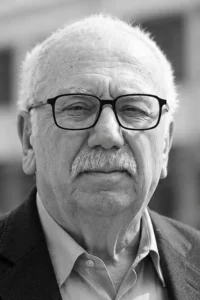 Customer testimonial headshot of an older man wearing glasses
