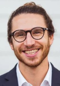 Customer testimonial headshot of a smiling man with glasses